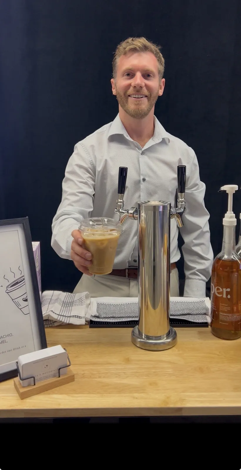Barista at the cold brew tap bar with draft cold brew and iced drinks