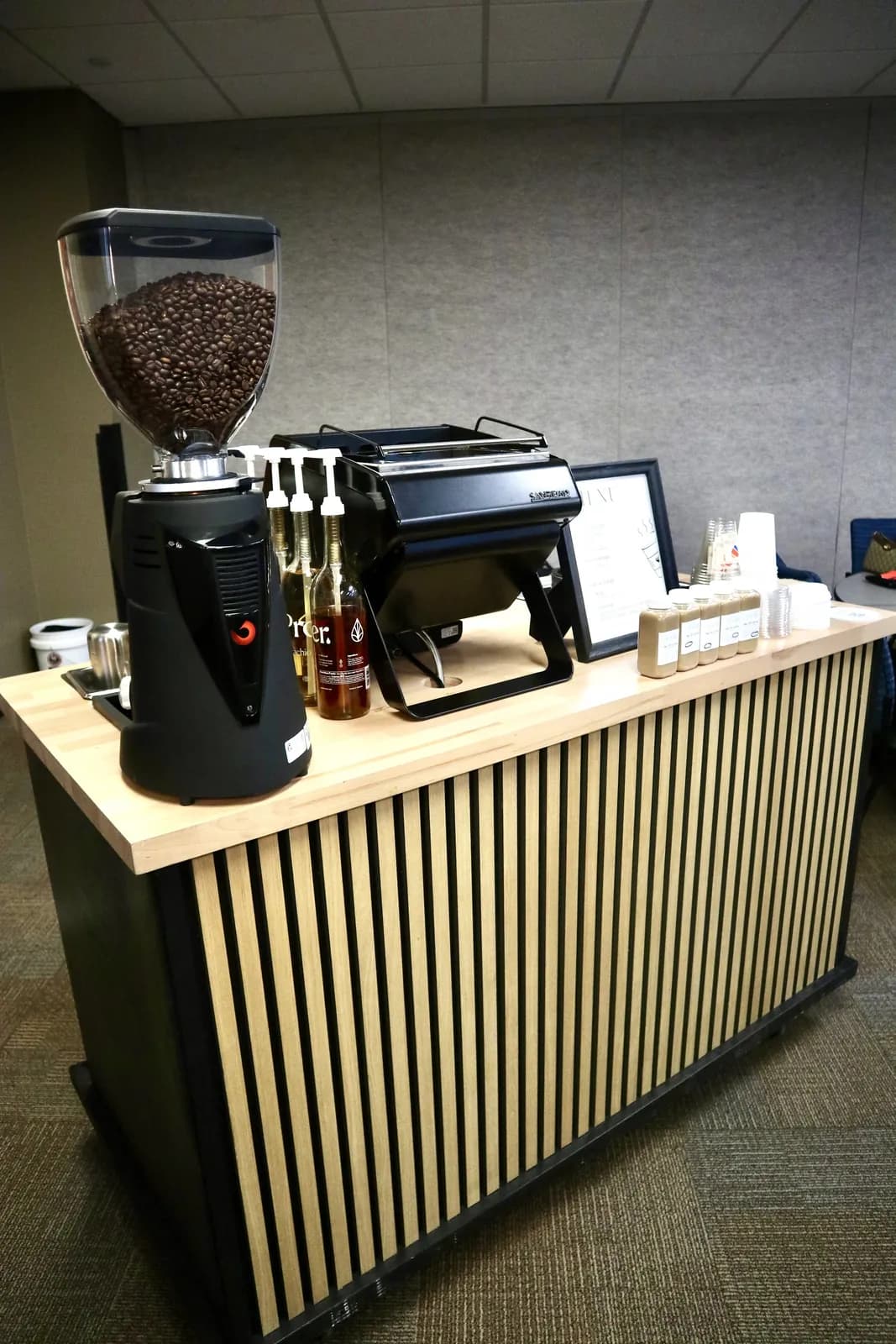 Mobile coffee cart with grinder and espresso machine set up indoors in Dallas